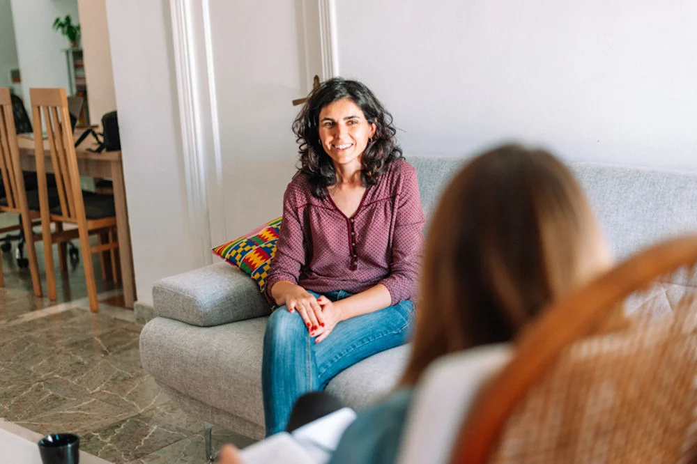 psychology and mental therapy concept - spanish woman patient an therapist explaining recovery in mental health treatment AL
