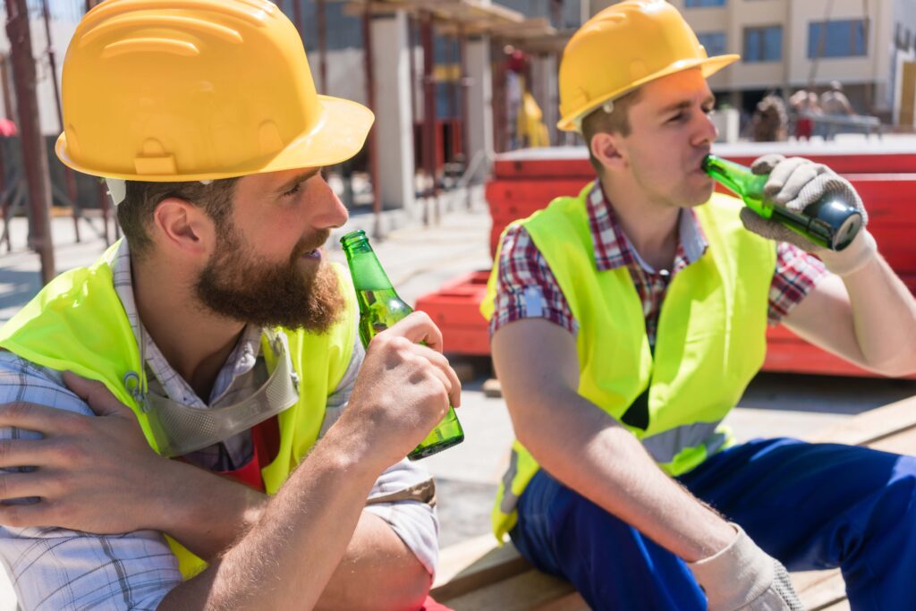 two workers on the job with alcohol addiction in birmingham