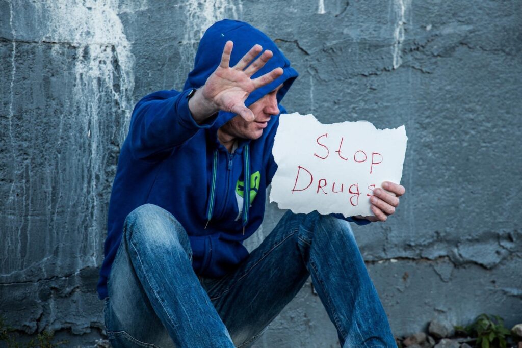 Man holding sign saying stop drugs