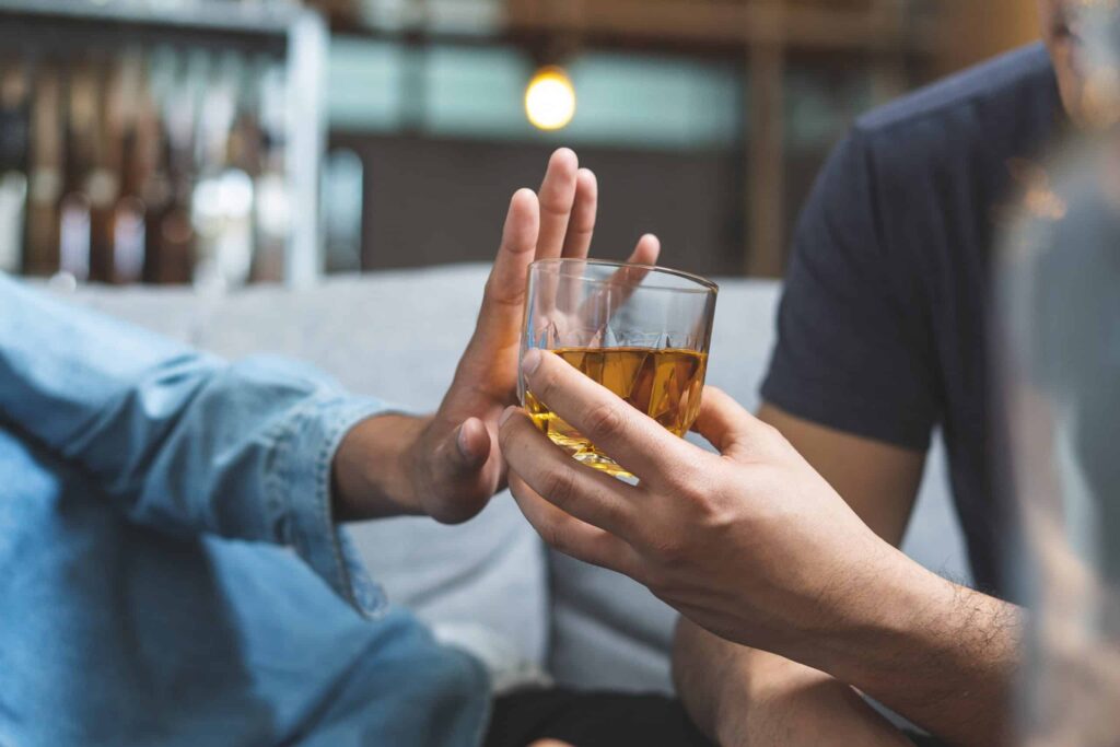 A person showing the early signs of alcohol addiction.