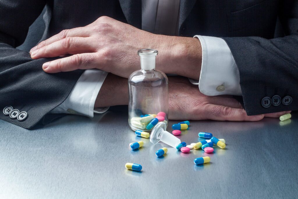 A man displaying signs of drug use at work.